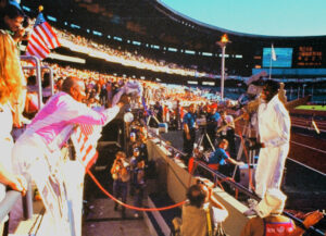 After winning a gold medal, Carl Lewis gives the award flowers to Sri Chinmoy